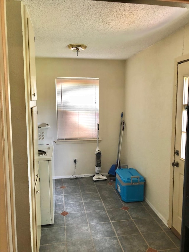 3107 Green Valley Ln, Arlington, TX 76014 - laundry area featuring tile patterned floors, a textured ceiling, and washer / clothes dryer