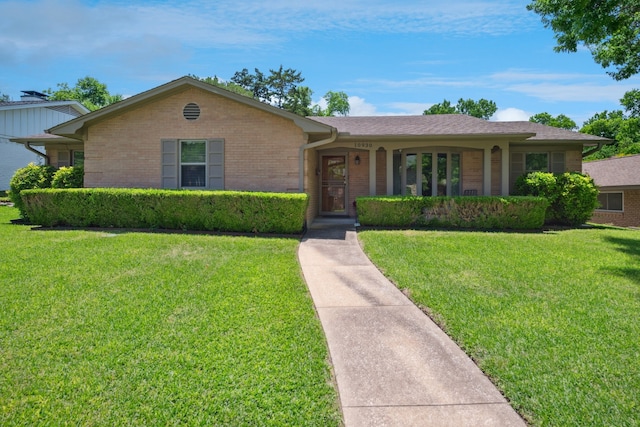 10930 Ridgemeadow Dr, Dallas, TX 75218 - single story home with brick siding and a front lawn
