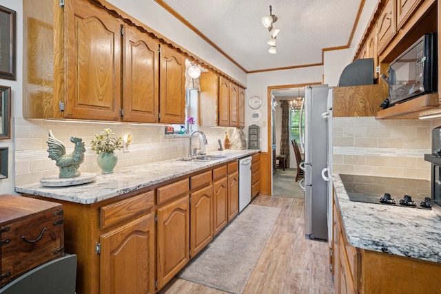 10930 Ridgemeadow Dr, Dallas, TX 75218 - kitchen featuring black appliances, a sink, ornamental molding, light wood-type flooring, and brown cabinets