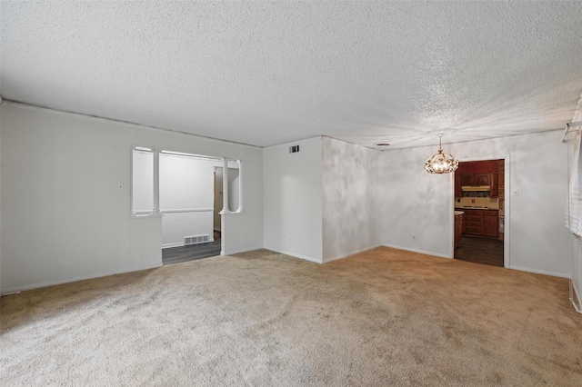 6330 Autumn Woods Trl, Dallas, TX 75232 - carpeted empty room featuring a chandelier, a textured ceiling, and baseboards