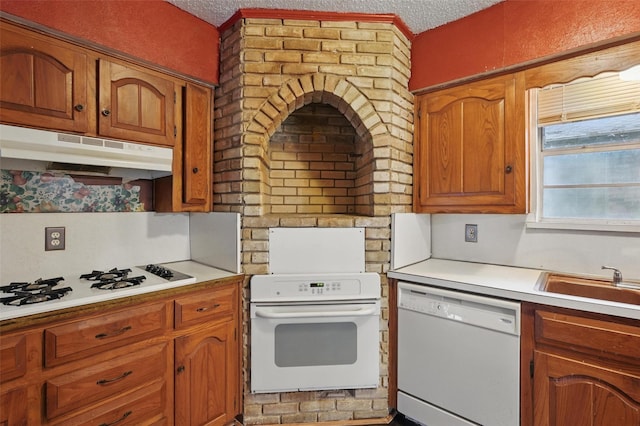 6330 Autumn Woods Trl, Dallas, TX 75232 - kitchen featuring white appliances, under cabinet range hood, a textured ceiling, light countertops, and a sink