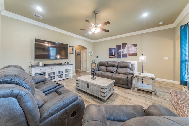 313 Donna Cir, Granbury, TX 76049 - living room featuring arched walkways, ceiling fan, baseboards, light wood finished floors, and ornamental molding