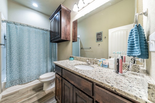 313 Donna Cir, Granbury, TX 76049 - bathroom featuring vanity, toilet, shower / bath combination with curtain, wood finished floors, and recessed lighting