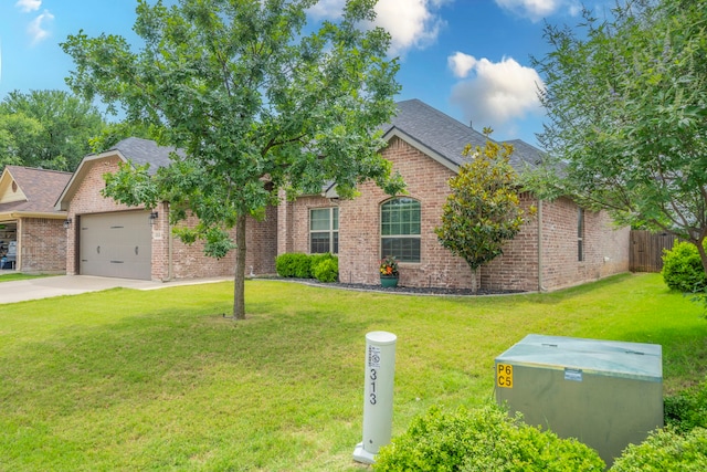 313 Donna Cir, Granbury, TX 76049 - view of front of property with an attached garage, driveway, brick siding, and roof with shingles