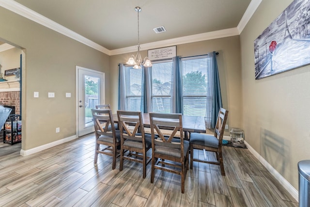 313 Donna Cir, Granbury, TX 76049 - dining area featuring wood finished floors, a chandelier, plenty of natural light, crown molding, and baseboards