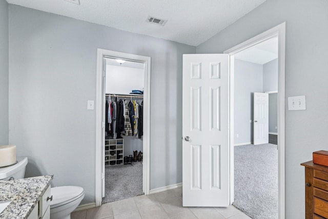 5789 Southfork Dr N, Royse City, TX 75189 - bathroom with vanity, a spacious closet, and tile patterned flooring