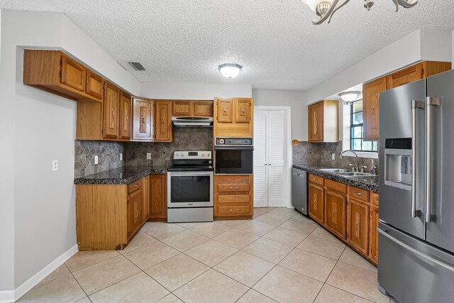 190 Rs County Road 4330, Point, TX 75472 - kitchen featuring stainless steel appliances, a sink, under cabinet range hood, tile countertops, and brown cabinets