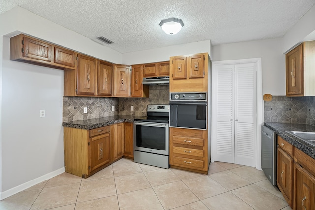 190 Rs County Road 4330, Point, TX 75472 - kitchen featuring stainless steel appliances, under cabinet range hood, brown cabinets, tile countertops, and a textured ceiling