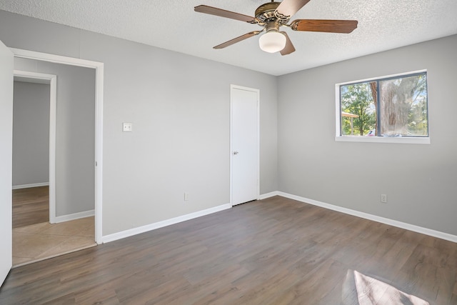 190 Rs County Road 4330, Point, TX 75472 - spare room with wood finished floors, ceiling fan, baseboards, and a textured ceiling