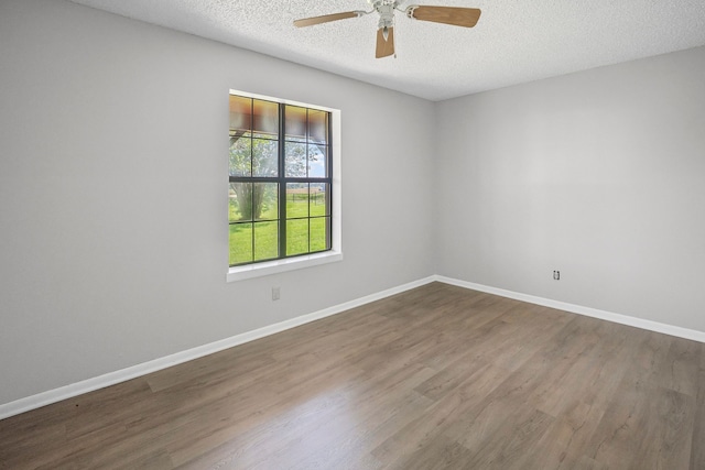 190 Rs County Road 4330, Point, TX 75472 - spare room with wood finished floors, a textured ceiling, a ceiling fan, and baseboards