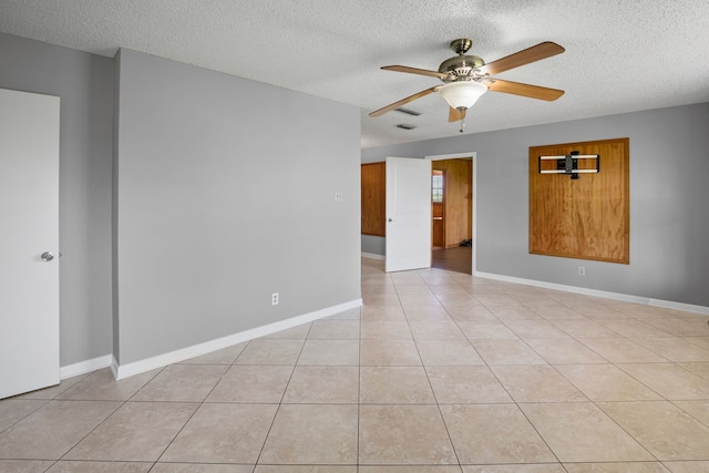 190 Rs County Road 4330, Point, TX 75472 - empty room featuring ceiling fan, a textured ceiling, light tile patterned floors, and baseboards