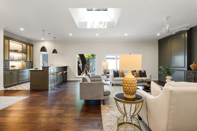 4315 Laren Ln, Dallas, TX 75244 - living area with dark wood-type flooring, ornamental molding, recessed lighting, baseboards, and a skylight