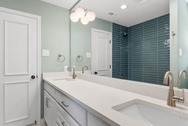 4315 Laren Ln, Dallas, TX 75244 - bathroom with double vanity, tiled shower, and recessed lighting