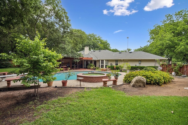 915 Cockrell Hill Rd, Ovilla, TX 75154 - back of property featuring an in-ground hot tub, an outdoor pool, a patio, and a chimney
