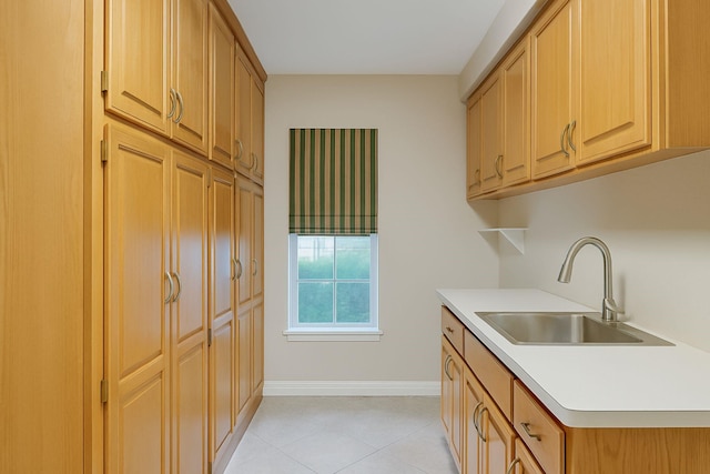 915 Cockrell Hill Rd, Ovilla, TX 75154 - kitchen featuring a sink, light countertops, light tile patterned flooring, and baseboards