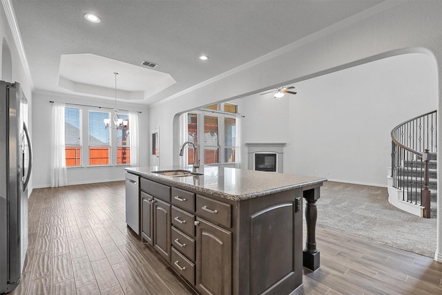 15232 Primrose Garden Ct, Aledo, TX 76008 - kitchen with a sink, appliances with stainless steel finishes, open floor plan, dark brown cabinets, and wood finished floors