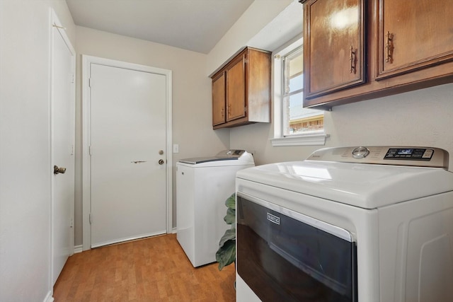 2500 Indian Hills Dr, Plano, TX 75075 - laundry room with cabinet space, washing machine and dryer, and light wood-style flooring