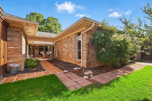 2500 Indian Hills Dr, Plano, TX 75075 - doorway to property with brick siding, a patio area, and a shingled roof