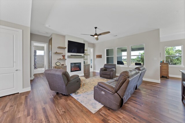 119 Cody Ave, Decatur, TX 76234 - living area featuring a glass covered fireplace, wood finished floors, ceiling fan, and baseboards