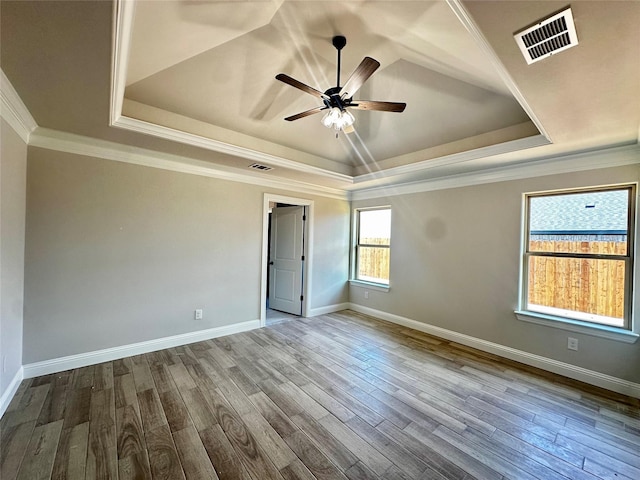1406 Oleander Dr, Tolar, TX 76476 - spare room with a raised ceiling, a ceiling fan, dark wood-style floors, baseboards, and crown molding