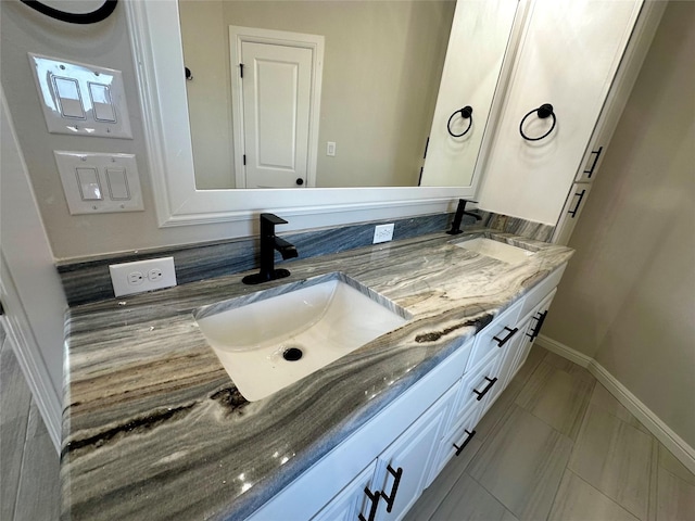 1406 Oleander Dr, Tolar, TX 76476 - bathroom featuring double vanity and baseboards