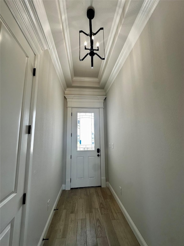 1406 Oleander Dr, Tolar, TX 76476 - doorway to outside featuring wood finished floors, crown molding, a chandelier, baseboards, and a raised ceiling