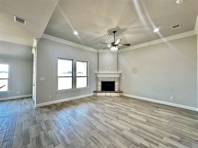 1406 Oleander Dr, Tolar, TX 76476 - unfurnished living room featuring a ceiling fan, ornamental molding, baseboards, wood finished floors, and a stone fireplace