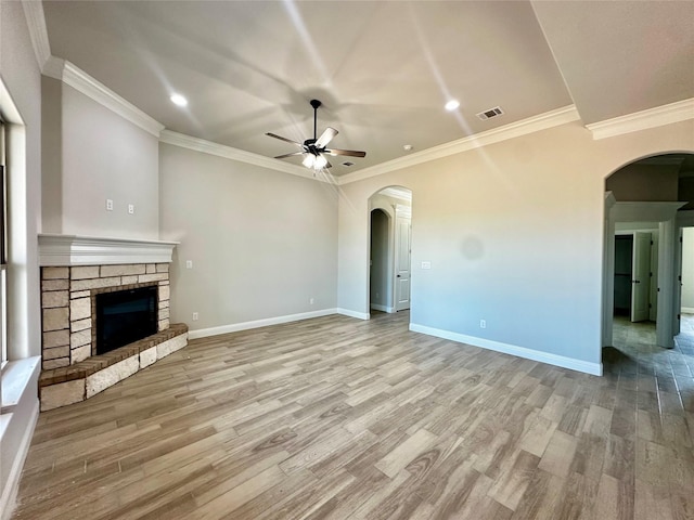 1406 Oleander Dr, Tolar, TX 76476 - unfurnished living room featuring arched walkways, ceiling fan, wood finished floors, recessed lighting, and crown molding