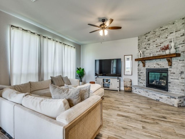 1241 Ronald St, Desoto, TX 75115 - living room featuring a ceiling fan, a stone fireplace, and wood finished floors