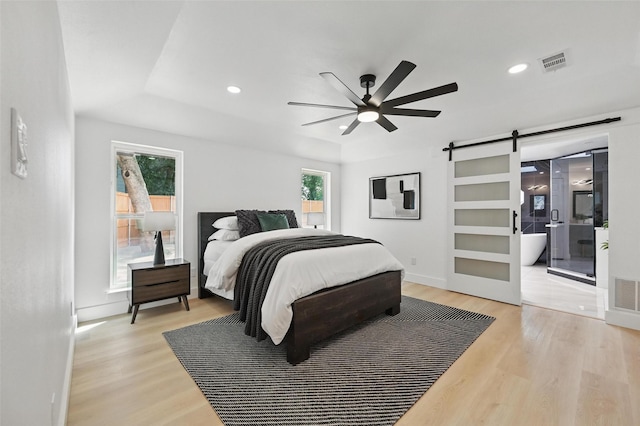 1429 Waterford Pl, Garland, TX 75044 - bedroom with a barn door, light wood-type flooring, recessed lighting, baseboards, and a ceiling fan