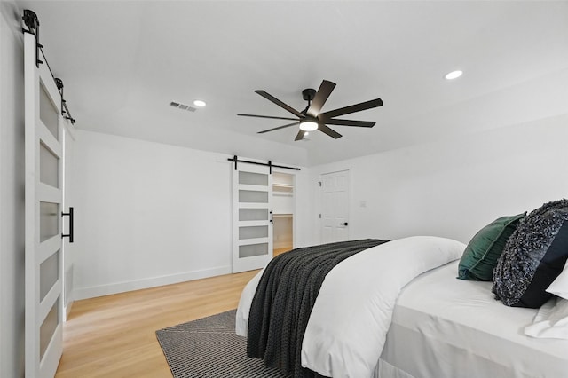 1429 Waterford Pl, Garland, TX 75044 - bedroom featuring a barn door, light wood-style floors, baseboards, recessed lighting, and a ceiling fan