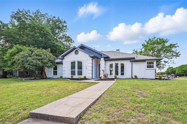 1429 Waterford Pl, Garland, TX 75044 - view of front of house featuring brick siding, a front yard, and roof with shingles