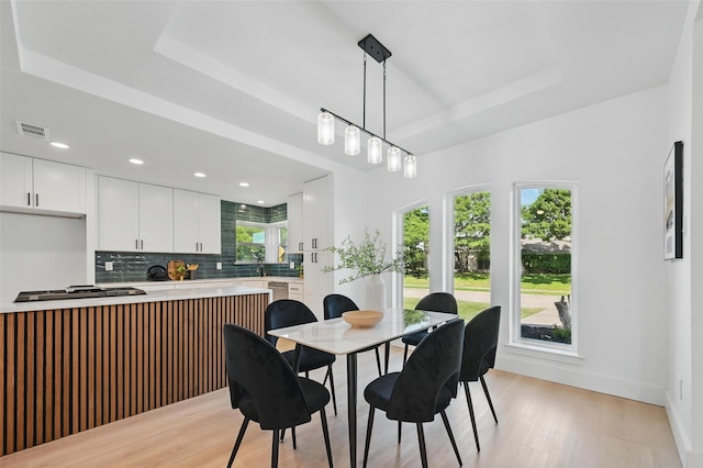 1429 Waterford Pl, Garland, TX 75044 - dining area featuring a raised ceiling, light wood-type flooring, baseboards, and recessed lighting