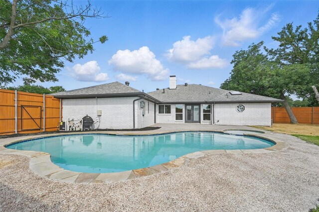 1429 Waterford Pl, Garland, TX 75044 - view of swimming pool featuring a patio area, a fenced backyard, and french doors