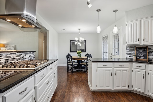 2928 Regal Rd, Plano, TX 75075 - kitchen with wall chimney exhaust hood, stainless steel gas cooktop, tasteful backsplash, and white cabinets