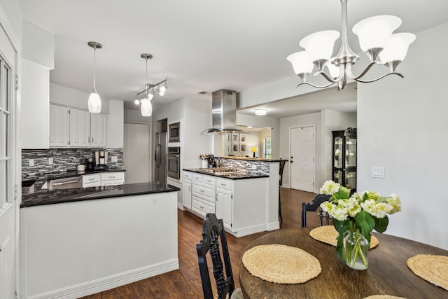 2928 Regal Rd, Plano, TX 75075 - kitchen with island range hood, a peninsula, dark countertops, appliances with stainless steel finishes, and backsplash