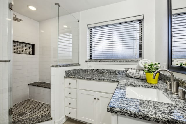 2928 Regal Rd, Plano, TX 75075 - bathroom with a shower stall, double vanity, healthy amount of natural light, and recessed lighting