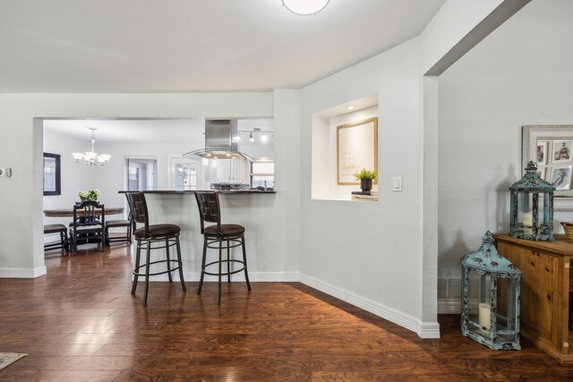 2928 Regal Rd, Plano, TX 75075 - kitchen featuring island exhaust hood, a chandelier, a kitchen bar, baseboards, and dark wood finished floors