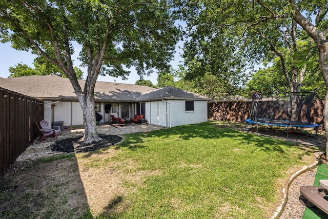 2928 Regal Rd, Plano, TX 75075 - view of yard featuring a trampoline and a patio area