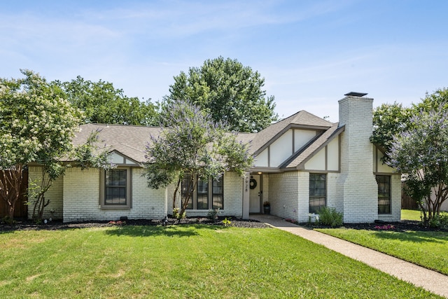 2928 Regal Rd, Plano, TX 75075 - view of front facade featuring brick siding, a chimney, a front lawn, and roof with shingles
