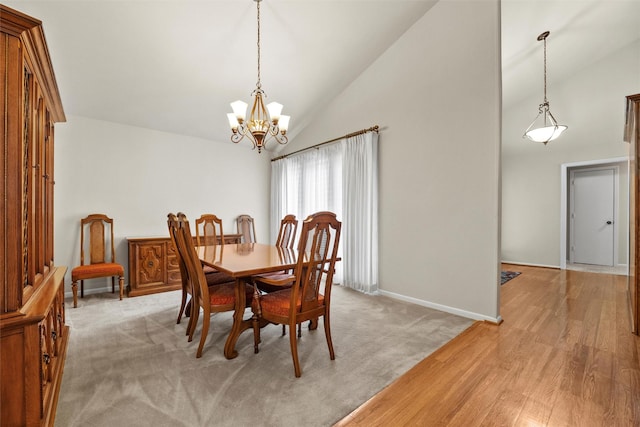 1210 Spring Lake Dr, Duncanville, TX 75137 - dining area with high vaulted ceiling, a chandelier, baseboards, and light wood-style floors
