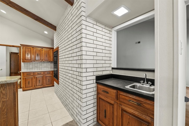 1210 Spring Lake Dr, Duncanville, TX 75137 - kitchen featuring a sink, brown cabinetry, light tile patterned flooring, decorative backsplash, and recessed lighting