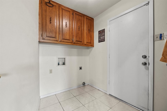 1210 Spring Lake Dr, Duncanville, TX 75137 - laundry room with cabinet space, hookup for a washing machine, electric dryer hookup, and light tile patterned floors