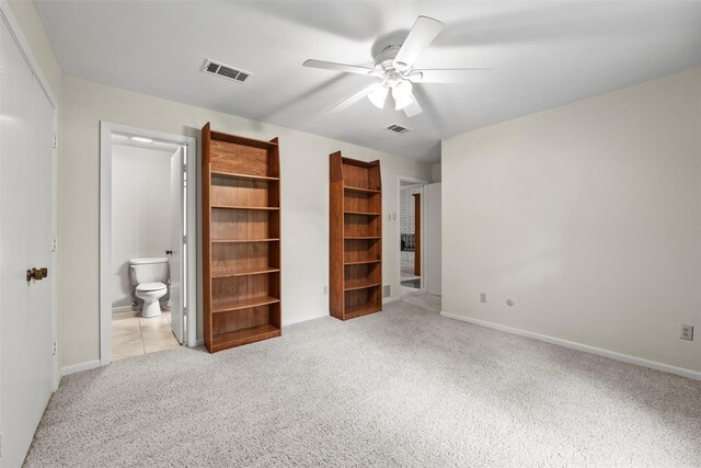 1210 Spring Lake Dr, Duncanville, TX 75137 - unfurnished bedroom with light carpet, ensuite bathroom, baseboards, and ceiling fan