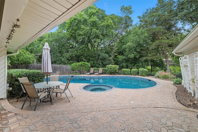 1210 Spring Lake Dr, Duncanville, TX 75137 - view of pool featuring a fenced backyard, a patio area, view of wooded area, and a pool with connected hot tub