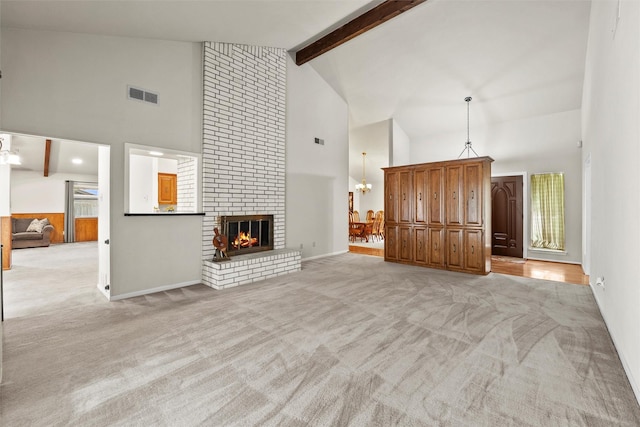 1210 Spring Lake Dr, Duncanville, TX 75137 - unfurnished living room featuring high vaulted ceiling, light carpet, a fireplace, beamed ceiling, and a chandelier