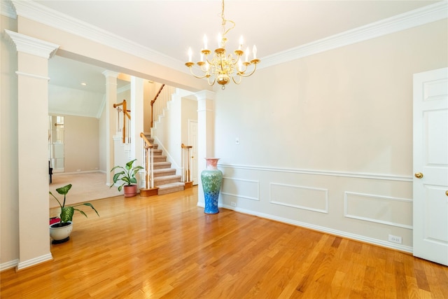 2017 Rumson Dr, Arlington, TX 76006 - unfurnished dining area featuring light wood-style floors, a chandelier, crown molding, decorative columns, and stairway