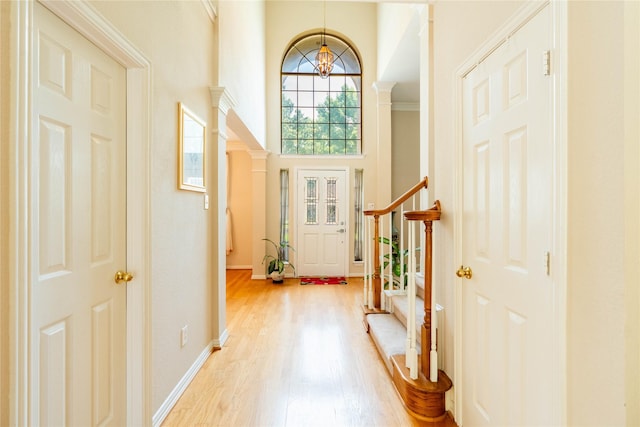 2017 Rumson Dr, Arlington, TX 76006 - entrance foyer with a chandelier, light wood-style floors, a towering ceiling, baseboards, and crown molding