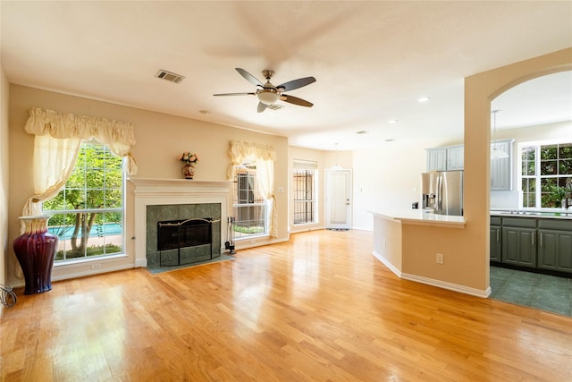 2017 Rumson Dr, Arlington, TX 76006 - living room with arched walkways, ceiling fan, plenty of natural light, light wood finished floors, and recessed lighting