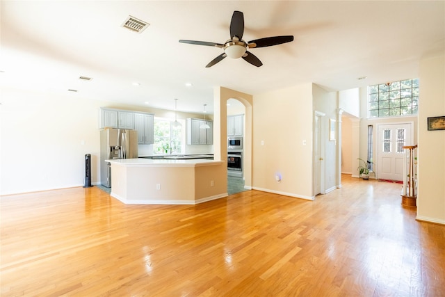 2017 Rumson Dr, Arlington, TX 76006 - unfurnished living room featuring healthy amount of natural light, ceiling fan, light wood-style floors, and recessed lighting